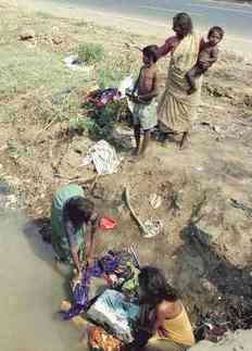 Poverty in India family washing
