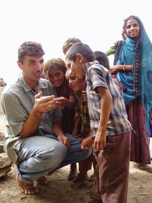 Man with children volunteering in india